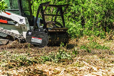 bobcat skid steer clearing land|bobcat land clearing attachments.